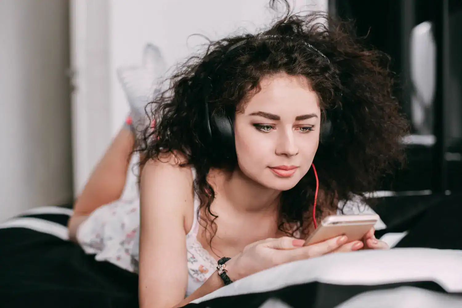 Young woman listening to music on her smartphone for relaxation.