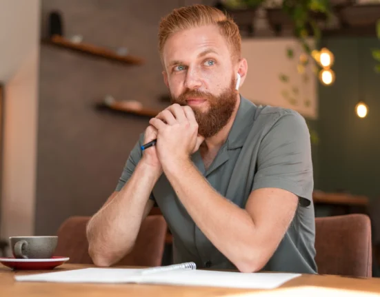 Thoughtful man contemplating risk and decision-making at a cafe.