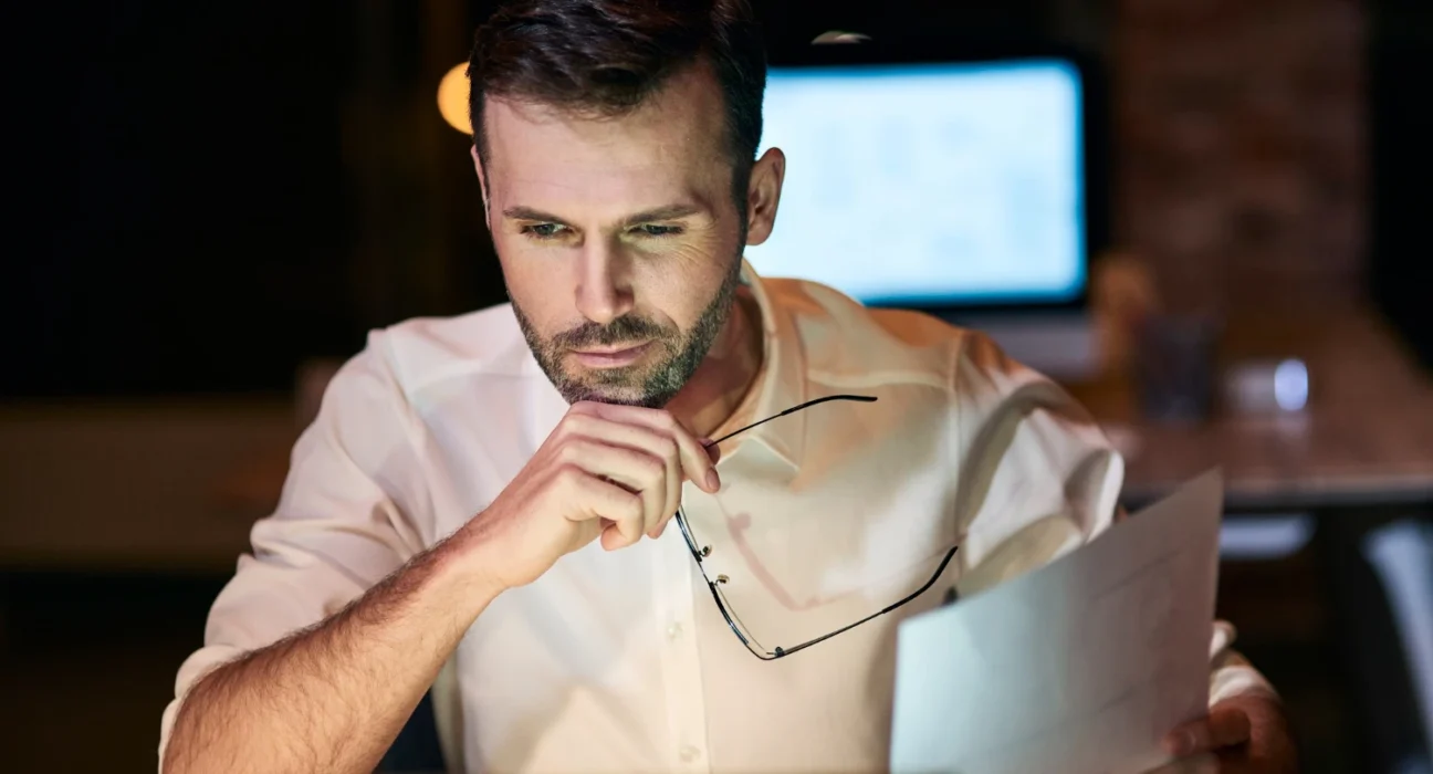 Man concentrating on work, emphasizing discipline over motivation.